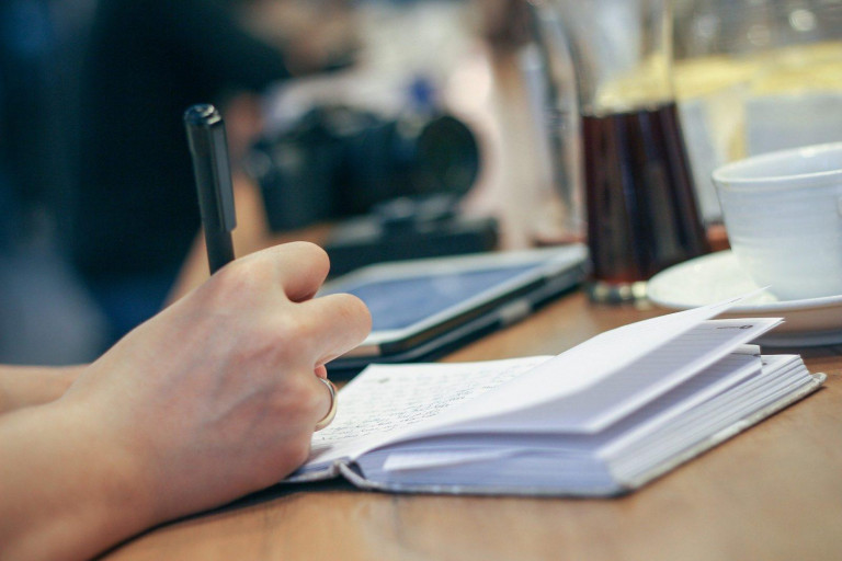 Photo of someone writing in notebook