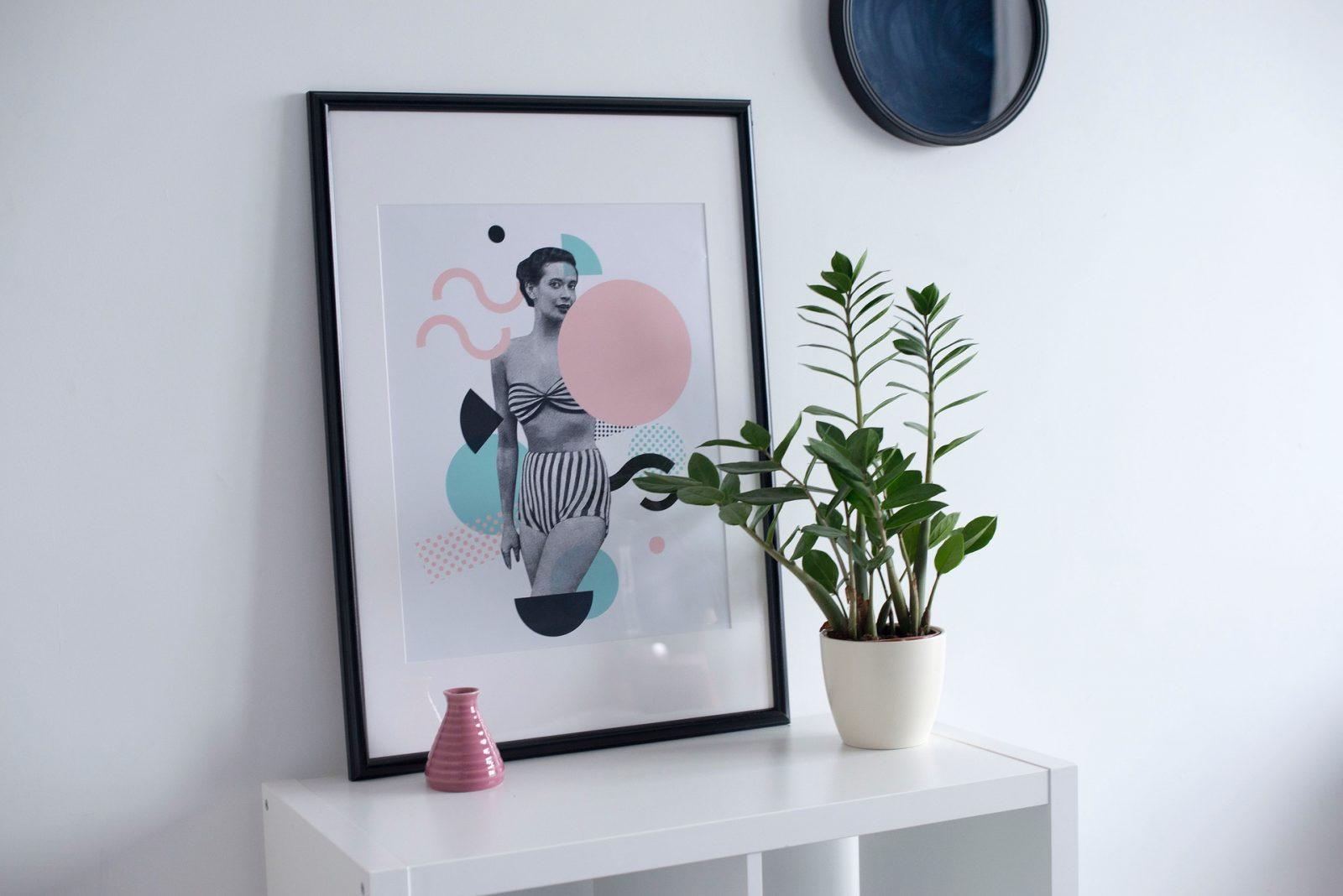 Potted plant, small vase and picture frame propped onto a shelf